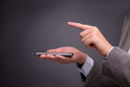 Businesswoman texting and sending text messagesの写真素材