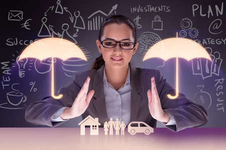 Young businesswoman in insurance conceptの写真素材