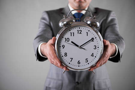 Businessman with clock in business concept