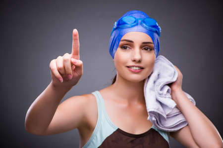 Woman swimmer against grey backgroundの写真素材