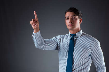 Handsome businessman pressing virtual buttonsの写真素材