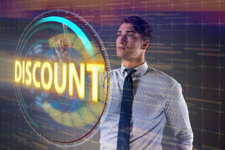 Young handsome businessman in sales conceptの写真素材