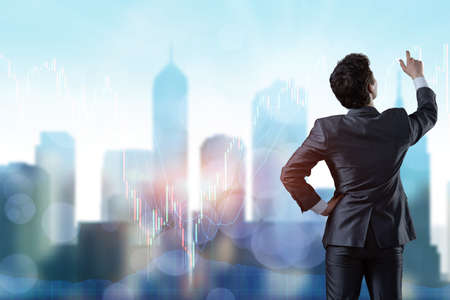 Man pressing buttons on line chartの写真素材