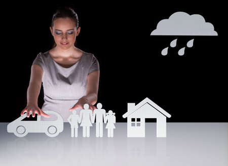 Young businesswoman in insurance conceptの写真素材