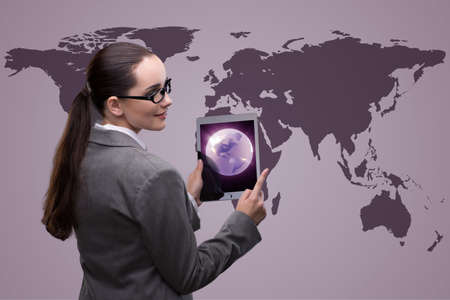Businesswoman with tablet in global business conceptの写真素材