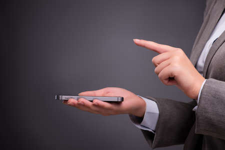 Businesswoman texting and sending text messagesの写真素材