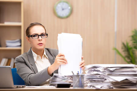Businesswoman under stress from too much work in the office