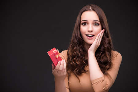 Young woman with giftbox and marriage proposalの写真素材