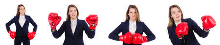 Woman businesswoman with boxing gloves on whiteの写真素材