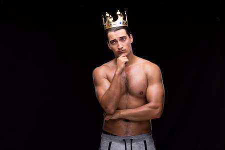 Ripped muscular man with king crownの写真素材