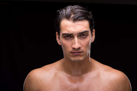 Ripped muscular handsome man on black background