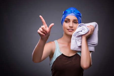 Woman swimmer against grey backgroundの写真素材