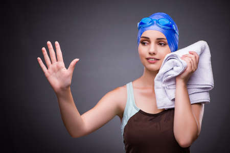 Woman swimmer against grey backgroundの写真素材