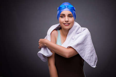 Woman swimmer against grey backgroundの写真素材