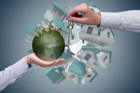 Young handsome businessman in mortgage conceptの写真素材