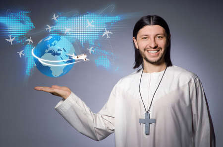 Young christian priest in air travel concept