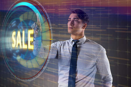 Young handsome businessman in sales conceptの写真素材