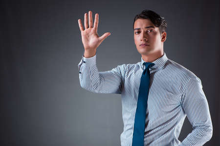 Handsome businessman pressing virtual buttonsの写真素材