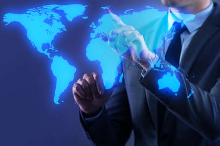 Businessman pressing virtual buttons in global business conceptの写真素材