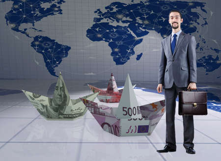 Businessman with dollar paper boatsの写真素材