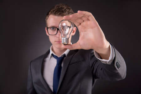 Young businessman with light bulb in idea conceptの写真素材