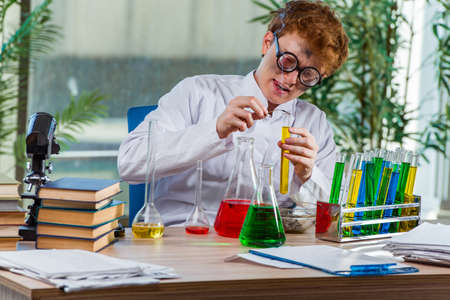 Young crazy chemist working in the labの写真素材