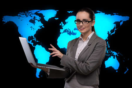 Businesswoman with laptop in global business conceptの写真素材