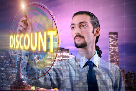 Young handsome businessman in sales conceptの写真素材