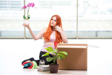 Young woman moving house in lifestyle conceptの写真素材