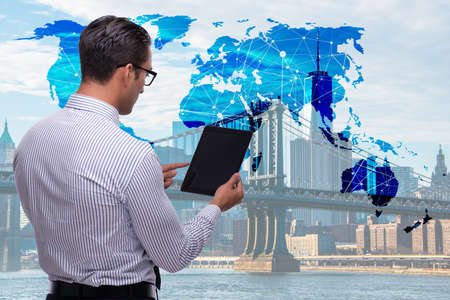 Businessman with tablet in global business conceptの写真素材