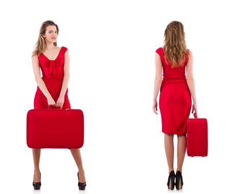 Young woman in red dress with suitcase isolated on whiteの写真素材