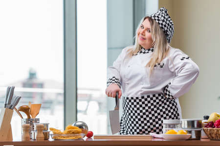 Young chef cook working in the kitchenの写真素材