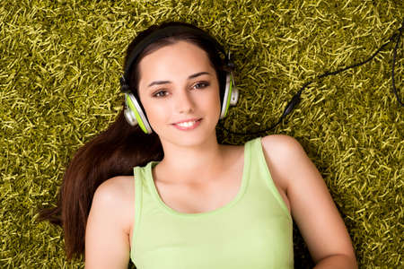 Young woman listening to music at homeの写真素材