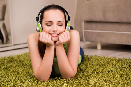 Young woman listening to music at homeの写真素材