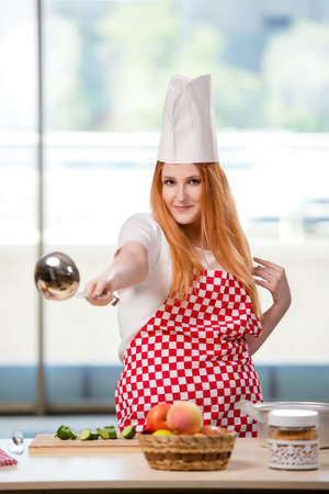 Redhead cook working in the kitchenの写真素材
