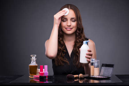Beautiful woman applying make-up in fashion concept