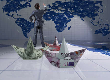 Businessman with dollar paper boatsの写真素材