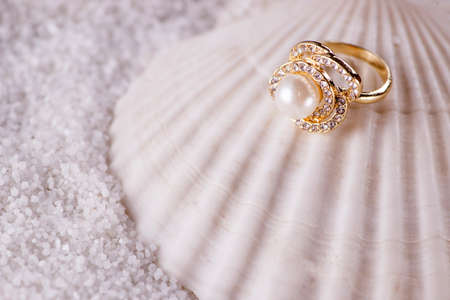 Golden ring and sea shellの写真素材