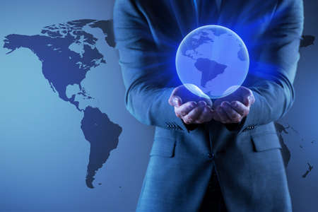 Businessman holding globe in global business conceptの写真素材