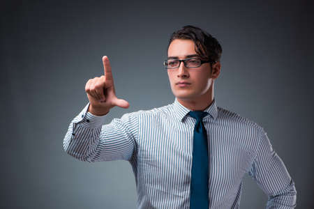 Handsome businessman pressing virtual buttonsの写真素材