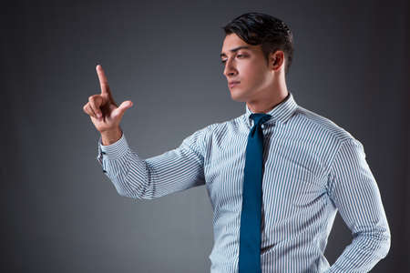 Handsome businessman pressing virtual buttonsの写真素材
