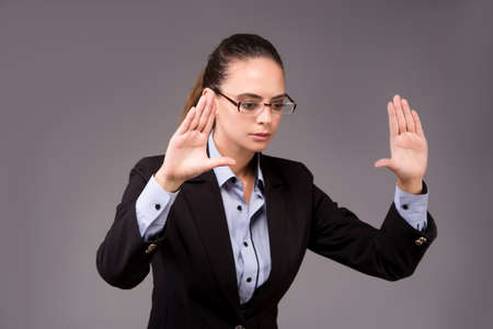 Young woman businesswoman pressing virtual buttonsの写真素材