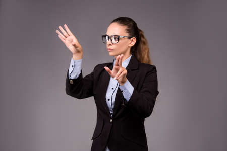 Young woman businesswoman pressing virtual buttonsの写真素材