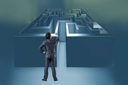 Businessman with maze in difficult situations conceptの写真素材