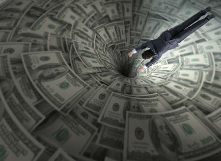 Businessman fighting against dollar funnelの写真素材