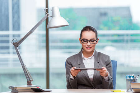 Businesswoman working with tablet computer in business conceptの写真素材