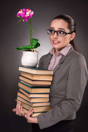 Young student with books and clockの写真素材