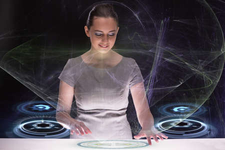 Businesswoman pressing abstract buttons in conceptの写真素材