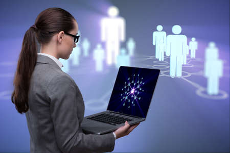 Businesswoman with laptop in social network conceptの写真素材