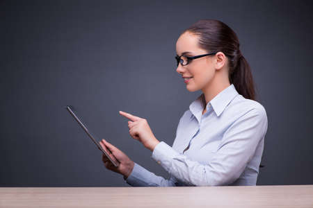 Businesswoman working with tablet computer in business conceptの写真素材